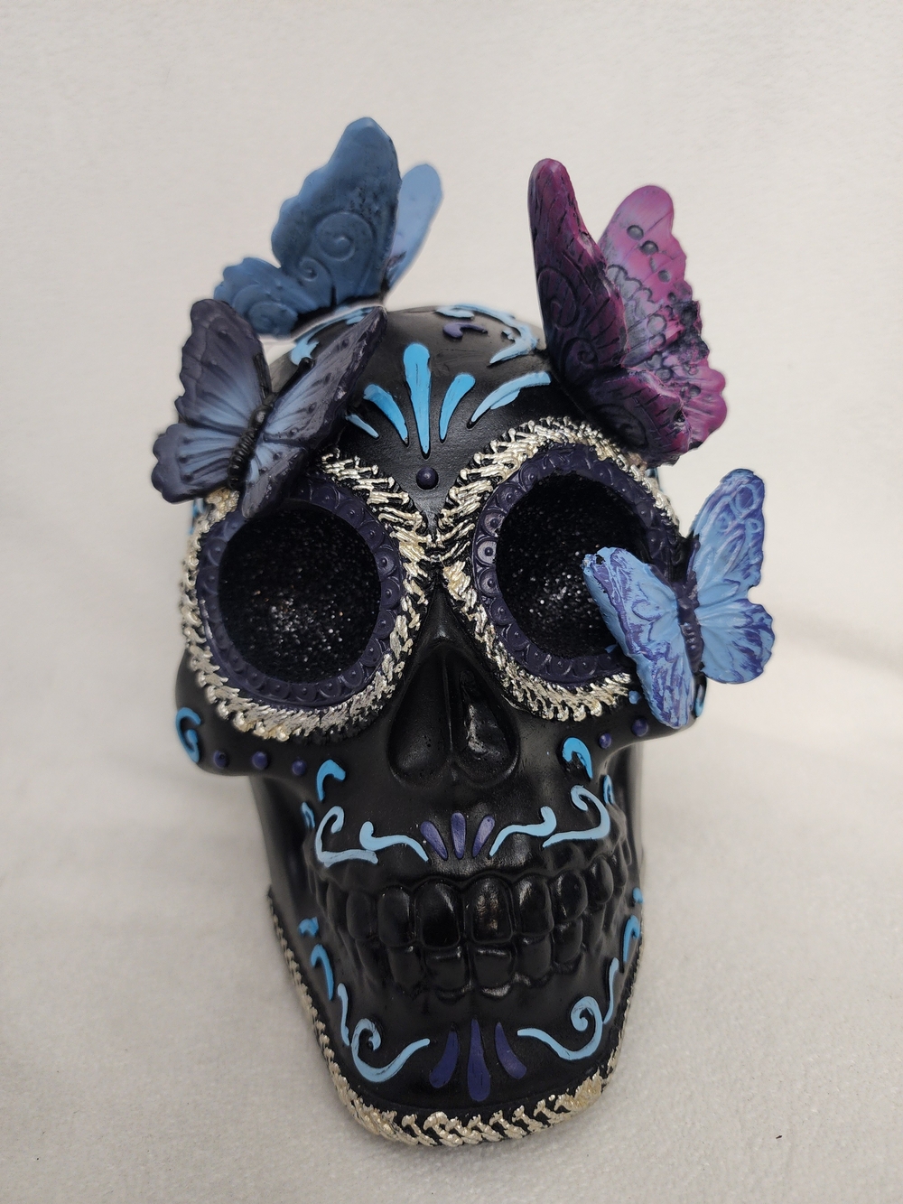 Decorative Black Dia de los Muertos Skull with Blue and Purple Butterflies